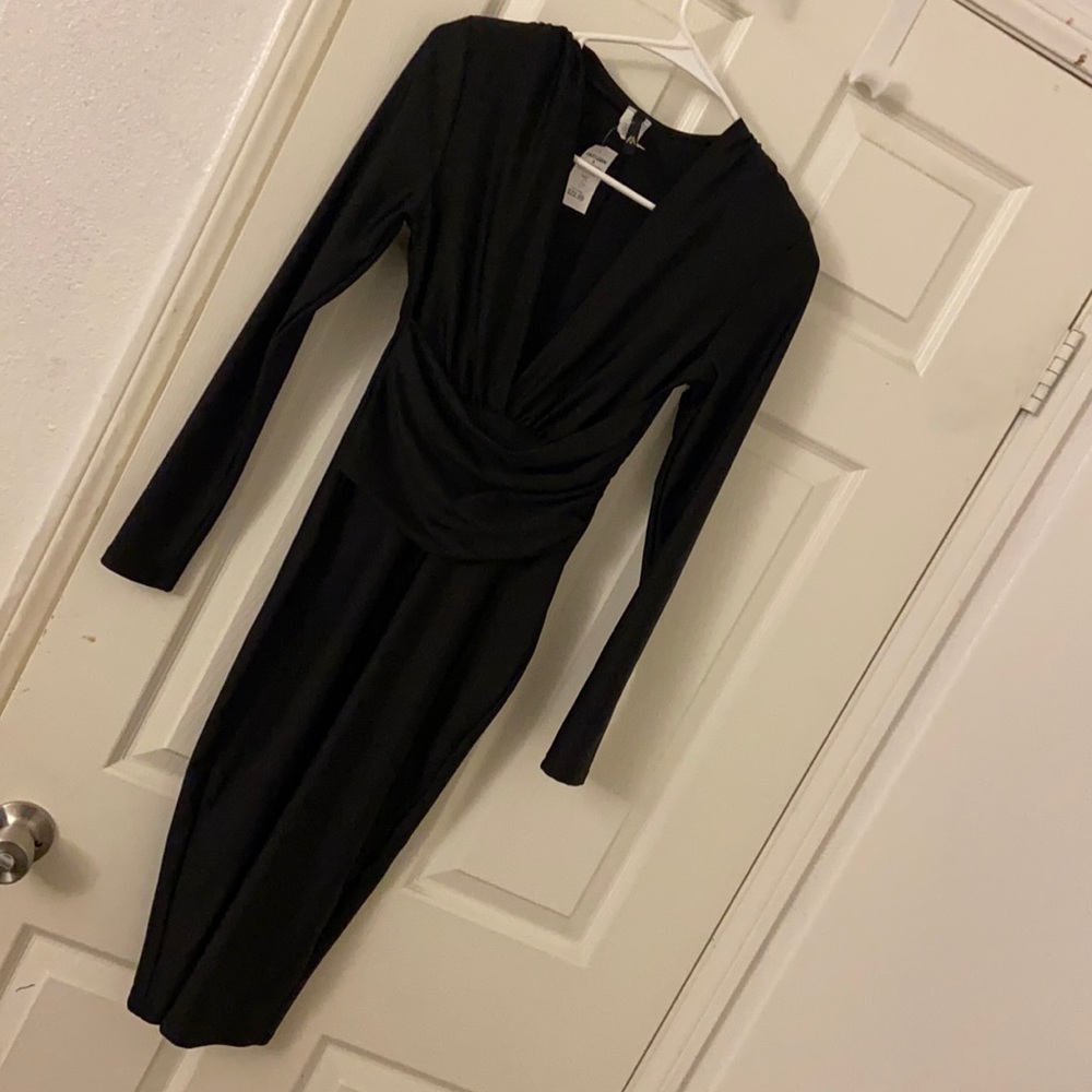 Black long sleeve low neckline tight fit knee length dress
